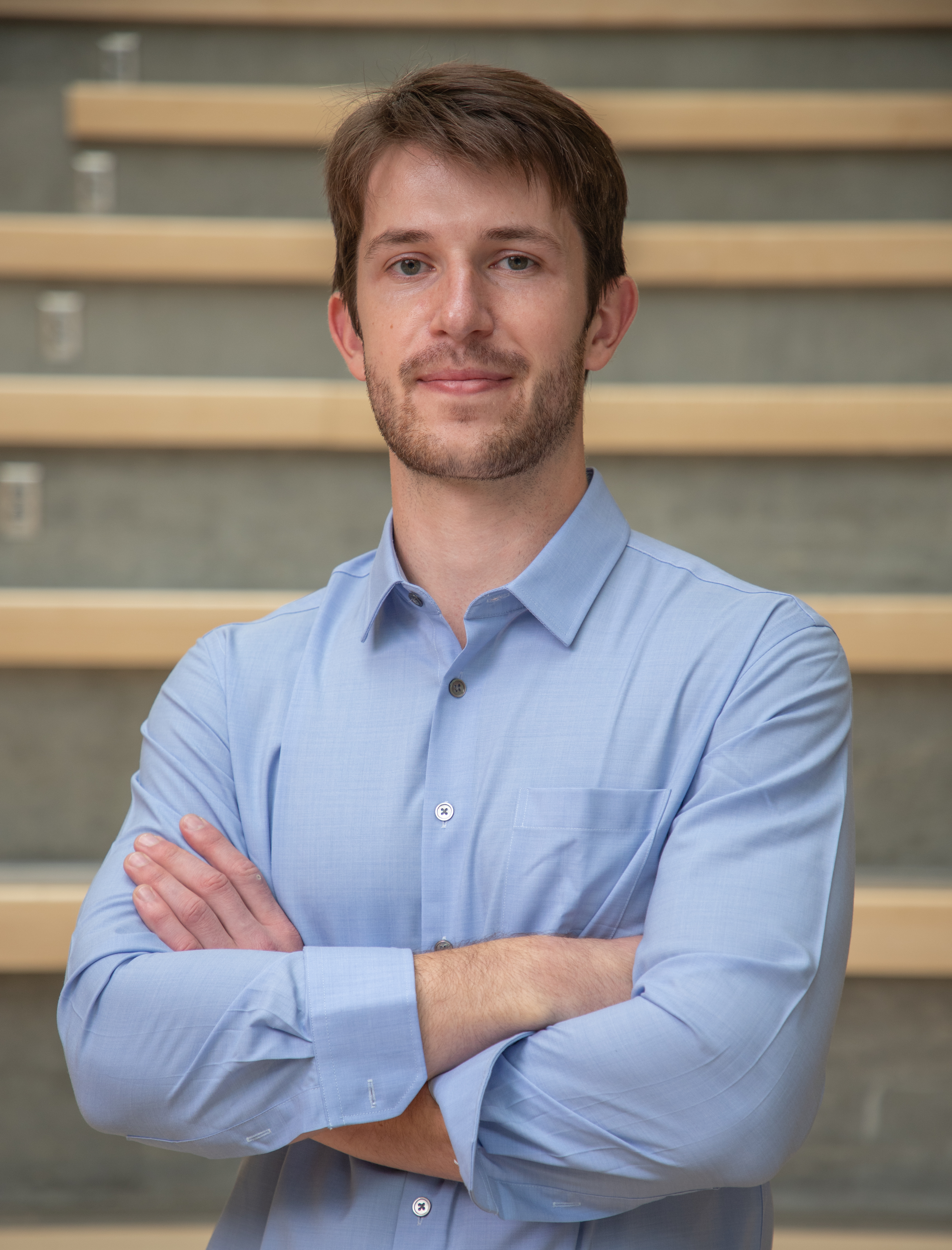Headshot of Marc Chenard, a stupendous loojing guy in a blue buttoned shirt.